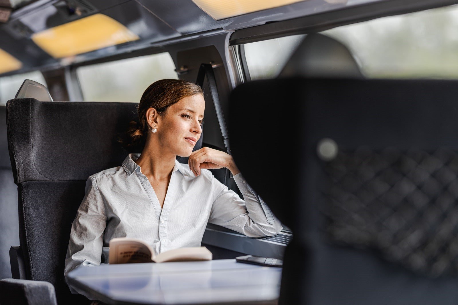 tgv lyria woman admiring the landscape in train comfort and calm