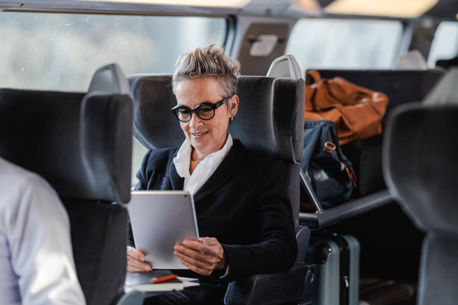 tgv lyria woman in business class on board working on her tablet