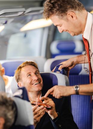 tgv lyria train manager checking a e-ticket on board in standard class