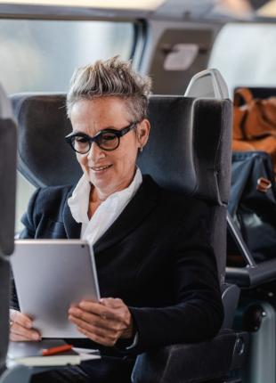 tgv lyria woman in business class on board working on her tablet