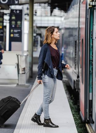 tgv lyria taveller with suitcase on platform station