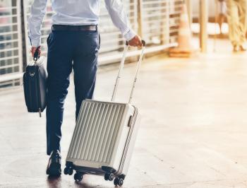 Traveller in the station with his suitcase