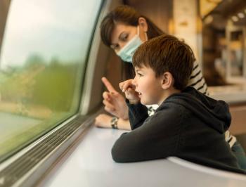 Family travellers relaxing in the TGV Lyria bar coach
