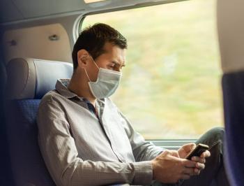 Man on board on his phone in 2nd class