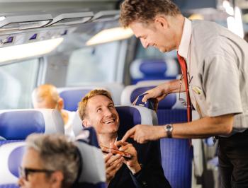 tgv lyria train manager checking a e-ticket on board in standard class