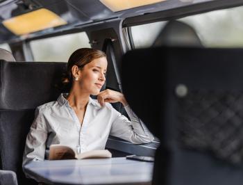 tgv lyria woman admiring the landscape in train comfort and calm