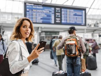 tgv lyria woman with smartphone at station