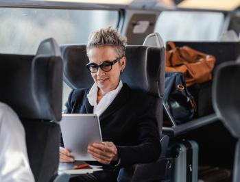 tgv lyria woman in business class on board working on her tablet