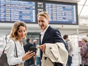 tgv lyria travellers in train station with smartphone