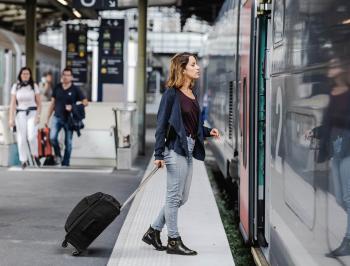 tgv lyria taveller with suitcase on platform station