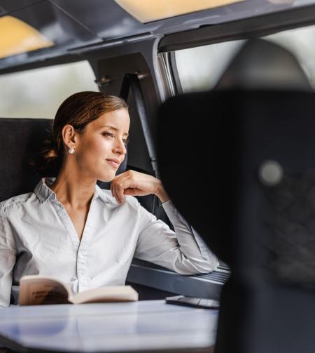 tgv lyria woman admiring the landscape in train comfort and calm