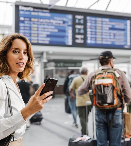 tgv lyria woman with smartphone at station